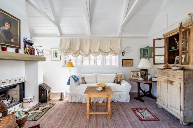 cottage family room with fireplace and balloon valances over window