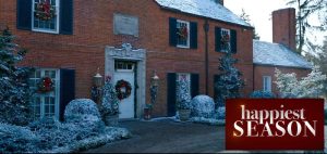 Closeup of house's red-brick exterior with shutters in "Happiest Season"