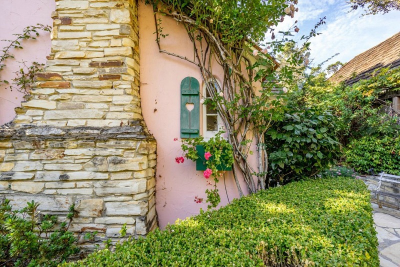 pink cottage with fireplace and shutters