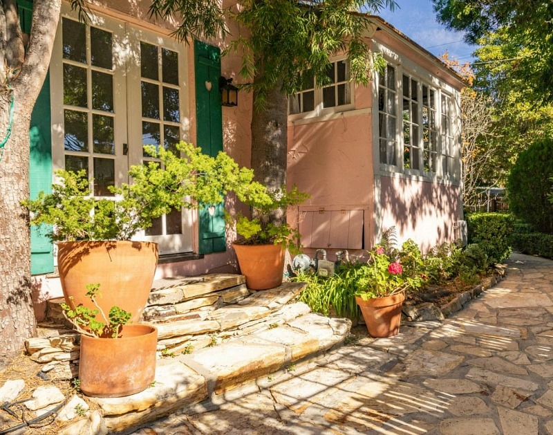 french doors with shutters on pink cottage in Carmel