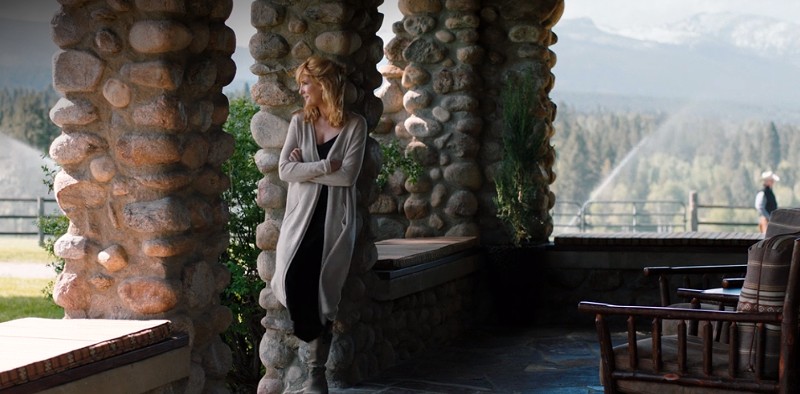 Beth Dutton on front porch of Yellowstone ranch