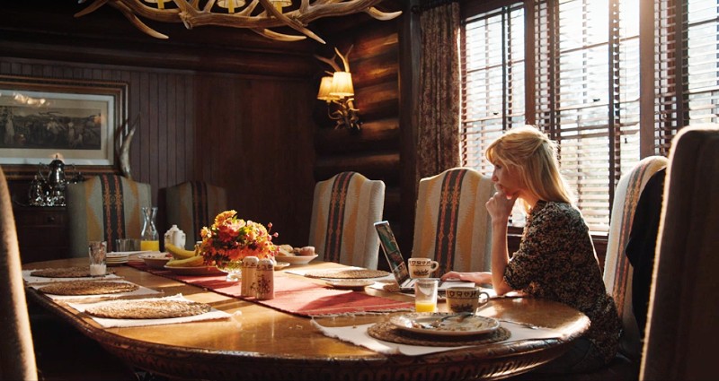 Beth Dutton sitting in dining room