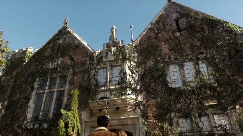 looking up at second story of haunted mansion in ghosts