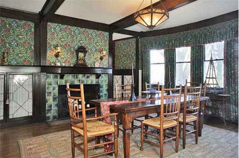 dining room with dark woodwork and wallpaper