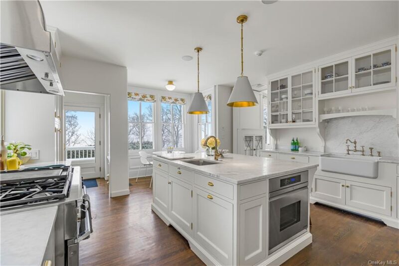 white kitchen with pendant lights over island