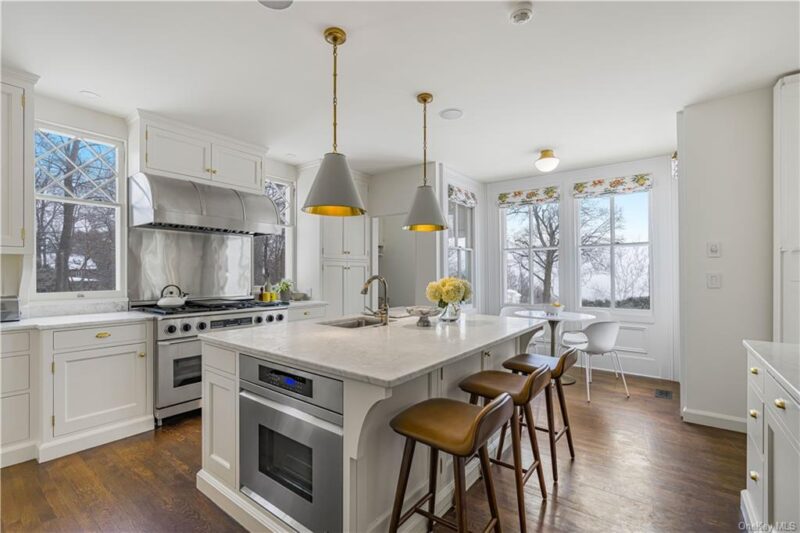 white kitchen with stainless steel range
