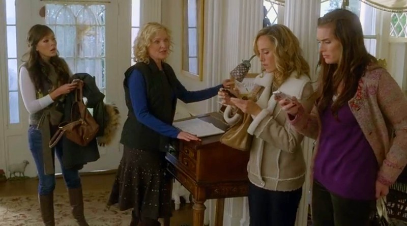 women gather in entry hall of house